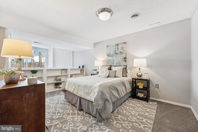 bedroom featuring a textured ceiling and carpet floors