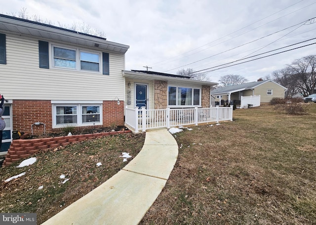 tri-level home with a front lawn