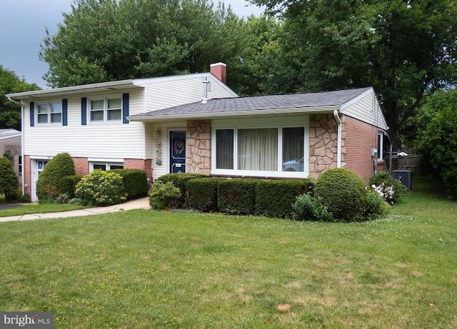 tri-level home with a front lawn