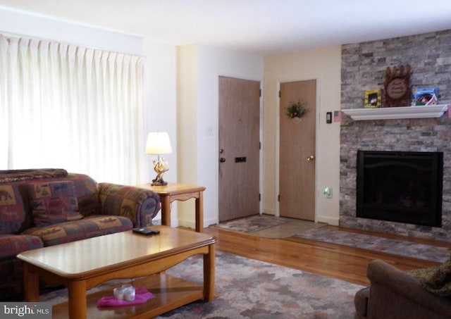 living room with hardwood / wood-style floors and a fireplace