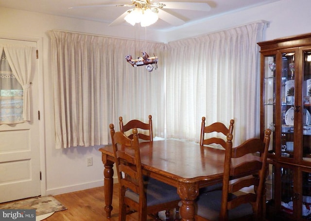 dining room with ceiling fan with notable chandelier and hardwood / wood-style floors