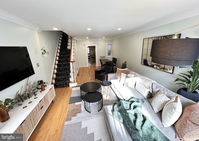 living room with light hardwood / wood-style flooring and crown molding