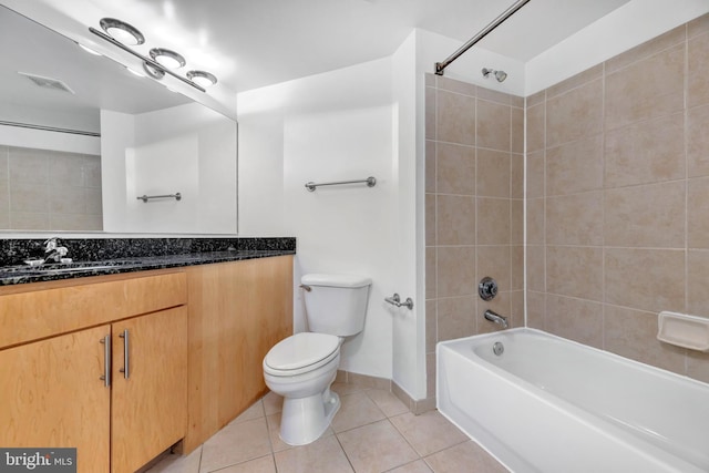 full bathroom featuring toilet, tiled shower / bath, tile patterned floors, and vanity