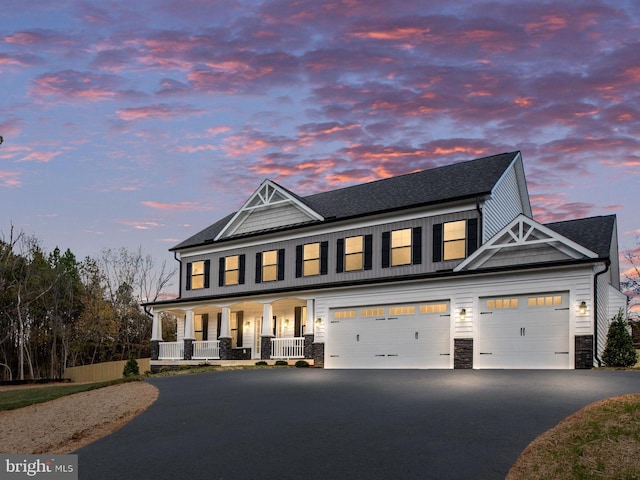 view of front of home featuring a porch and a garage