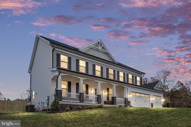 view of front of house with a yard, central AC unit, and covered porch