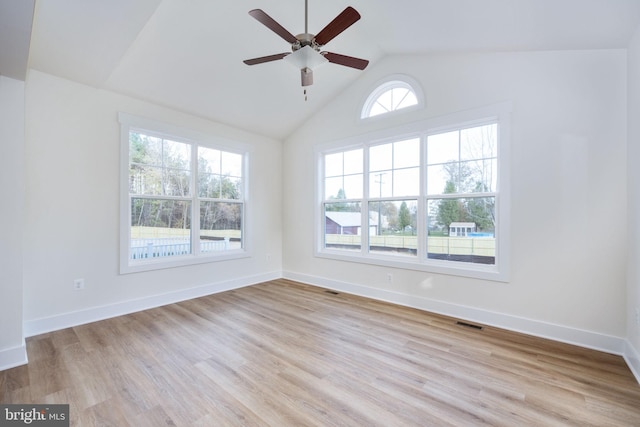 unfurnished room with vaulted ceiling, ceiling fan, and light hardwood / wood-style floors