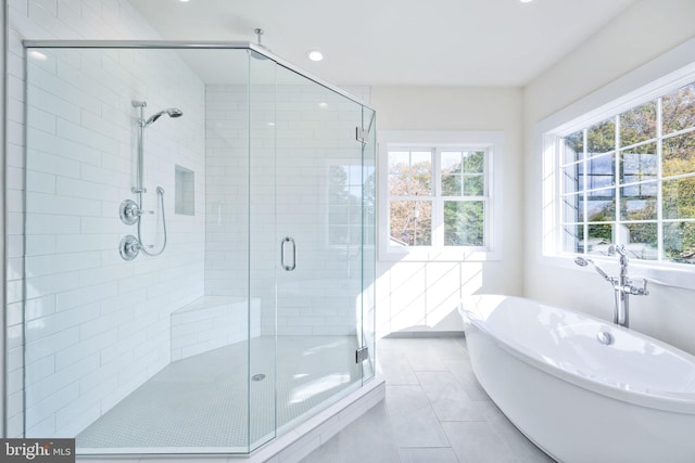 bathroom featuring shower with separate bathtub and tile patterned floors