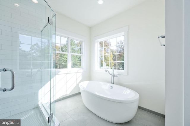 bathroom featuring tile patterned flooring and independent shower and bath