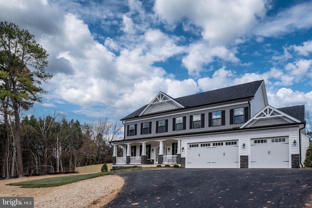 view of front of property with a garage and covered porch