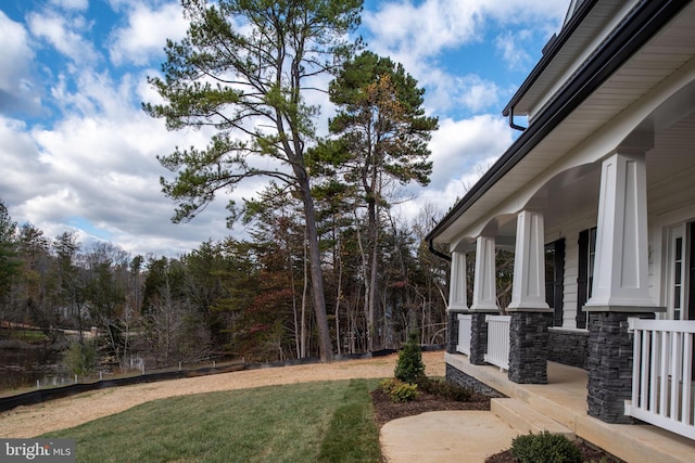 view of yard with covered porch