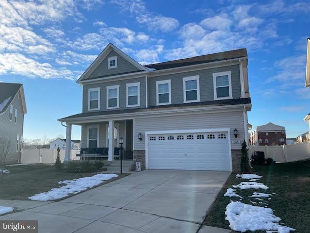 view of front of property featuring a garage and a porch