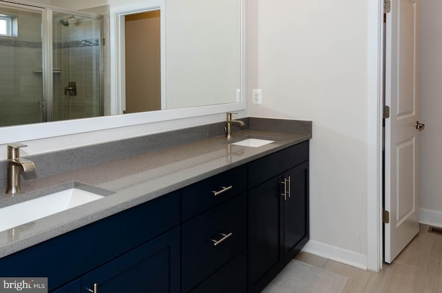 bathroom with walk in shower and vanity