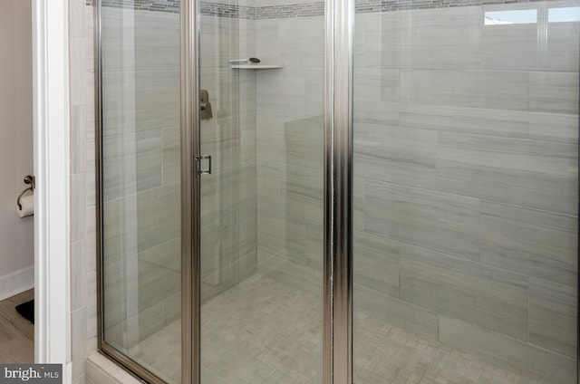 bathroom featuring a shower with door