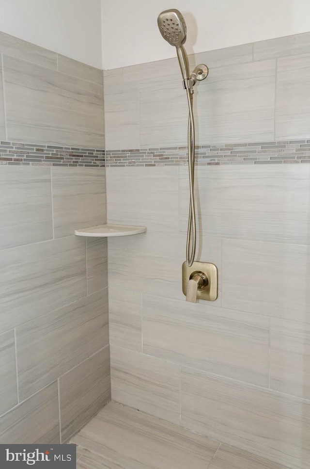 bathroom with tiled shower