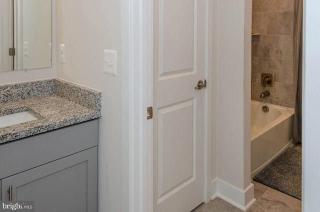 bathroom featuring vanity, tile patterned flooring, and  shower combination