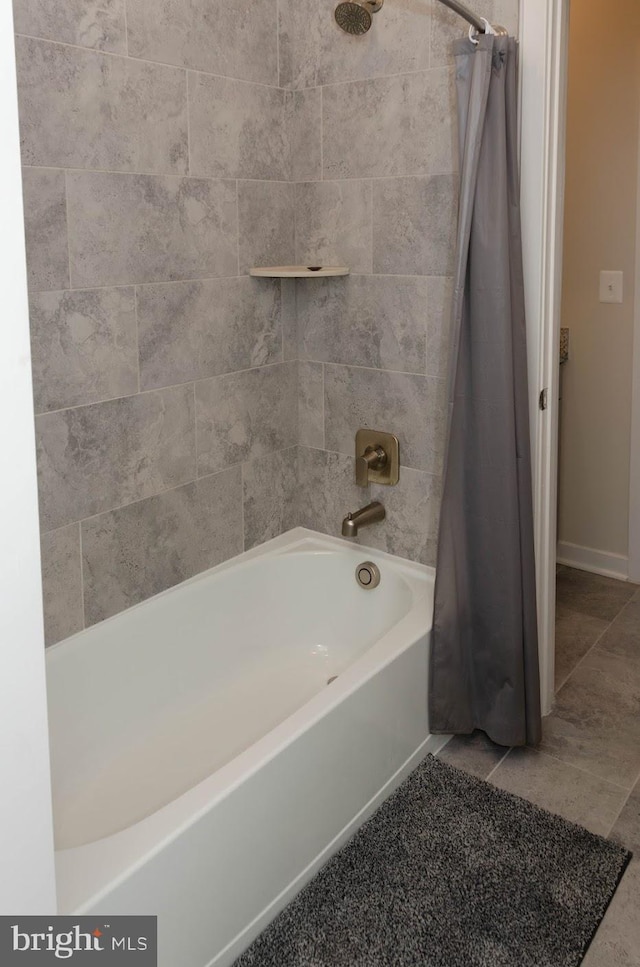 bathroom with tile patterned floors and shower / bath combo