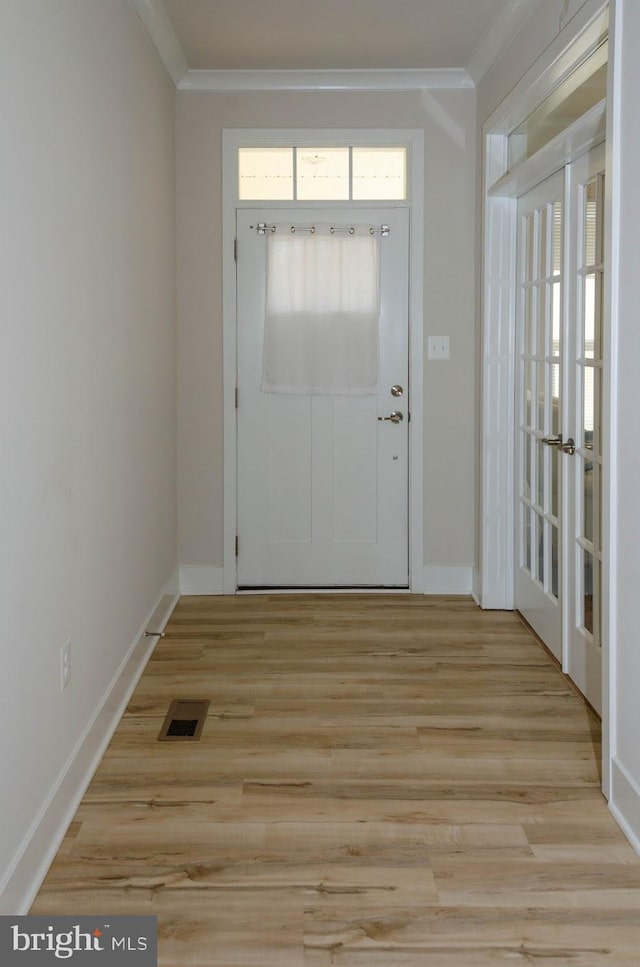 foyer entrance featuring light hardwood / wood-style flooring and ornamental molding