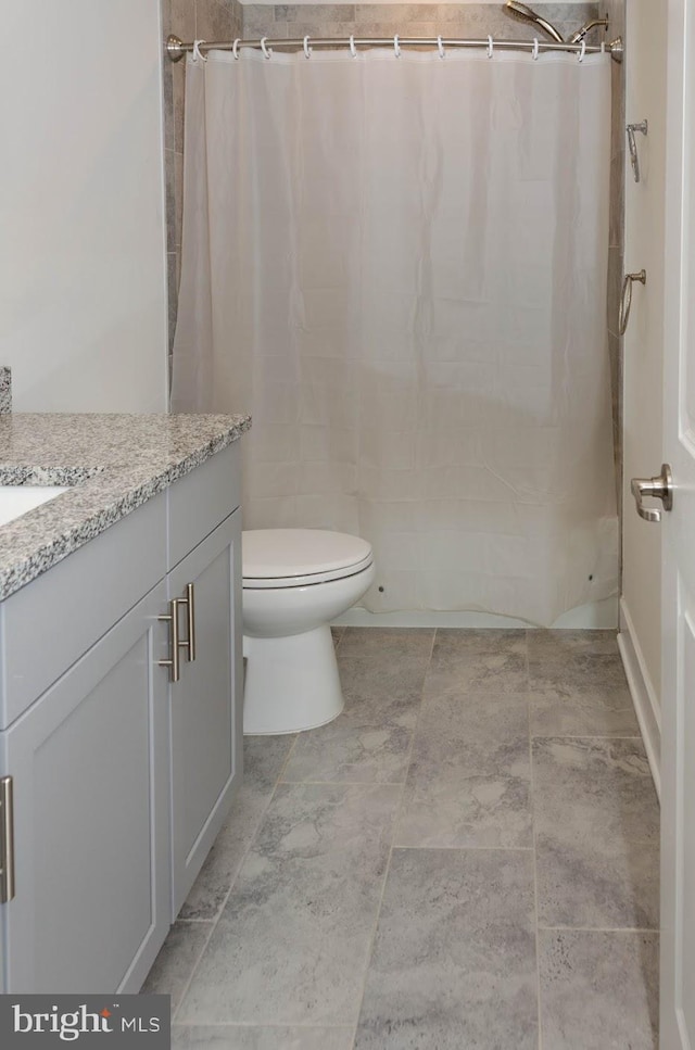 bathroom featuring vanity, a shower with curtain, and toilet