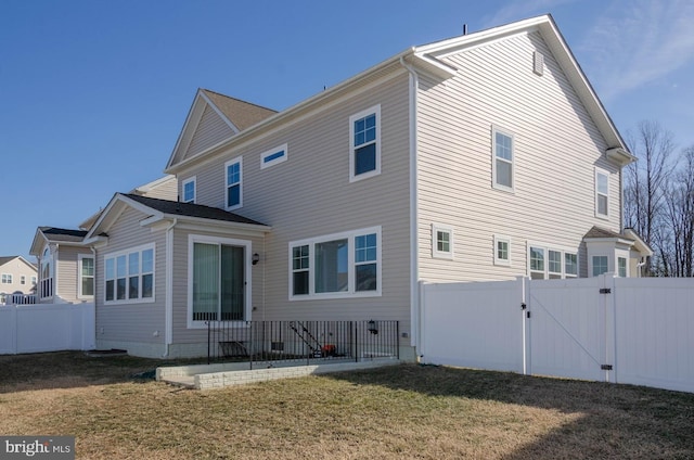 rear view of house featuring a yard and a patio area