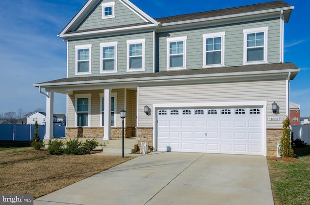 craftsman inspired home with a garage and covered porch