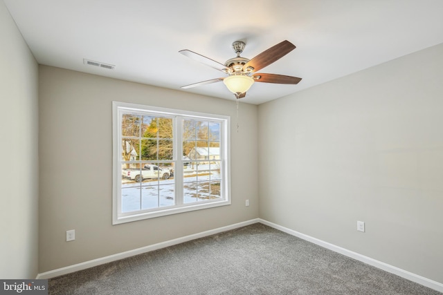 unfurnished room featuring ceiling fan and carpet