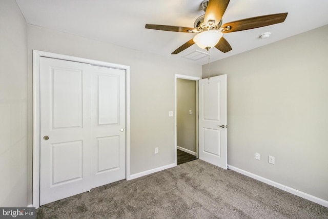 unfurnished bedroom featuring ceiling fan, a closet, and dark carpet