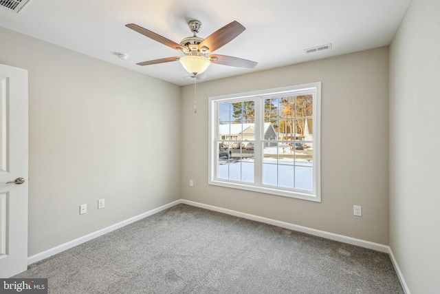 carpeted empty room featuring ceiling fan