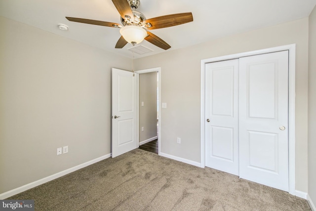 unfurnished bedroom with ceiling fan, a closet, and carpet