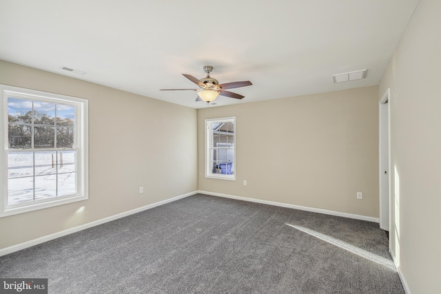 carpeted spare room featuring ceiling fan