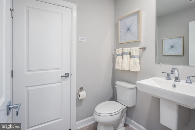 bathroom featuring sink and toilet