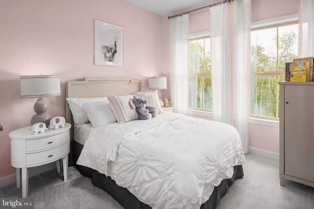 carpeted bedroom featuring multiple windows