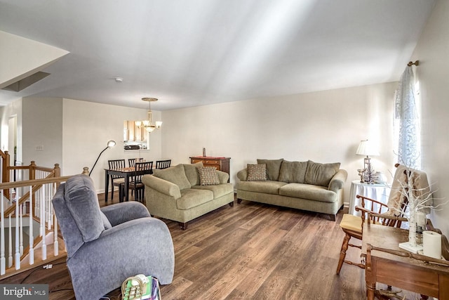 living room featuring dark hardwood / wood-style flooring and a chandelier