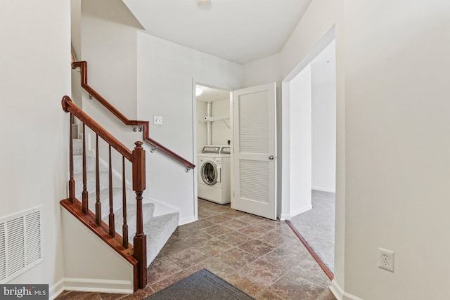 foyer entrance with washer and clothes dryer