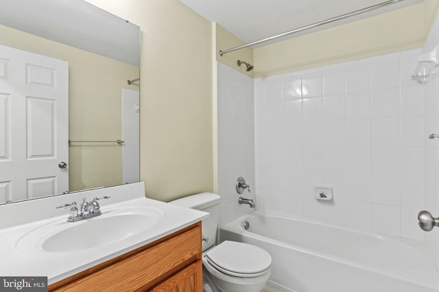 full bathroom with vanity, tiled shower / bath, and toilet