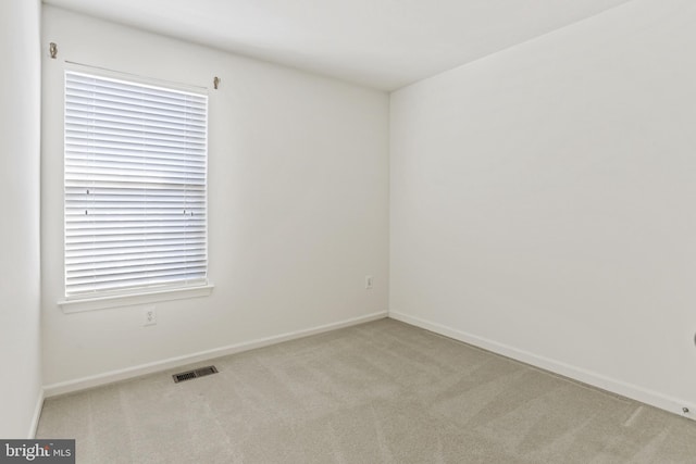 unfurnished room with light carpet