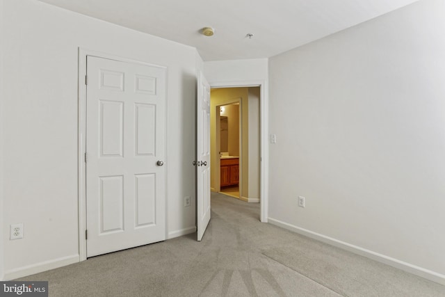 unfurnished bedroom featuring light colored carpet