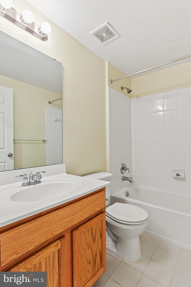 full bathroom featuring tiled shower / bath, vanity, toilet, and tile patterned flooring