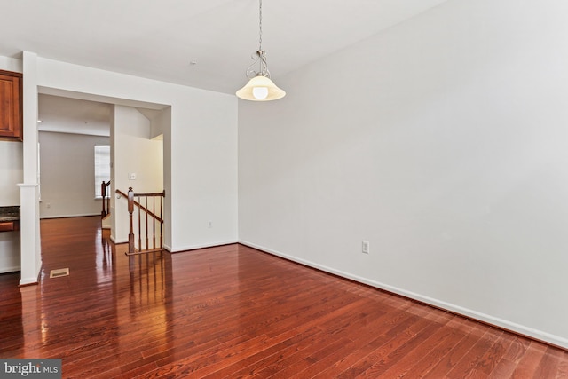 spare room featuring dark hardwood / wood-style flooring