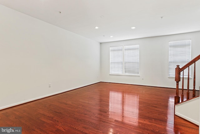 unfurnished room with dark hardwood / wood-style flooring