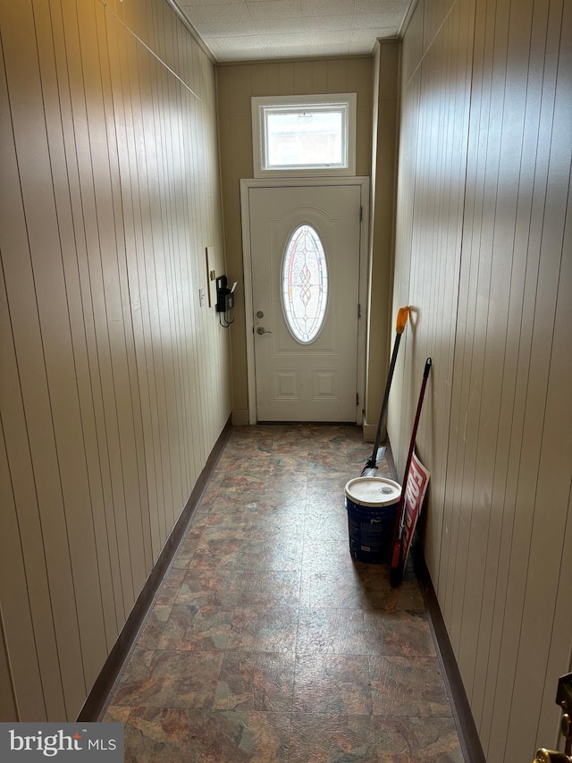 entryway with wooden walls