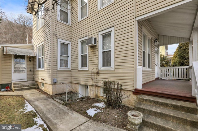 view of side of property with an AC wall unit