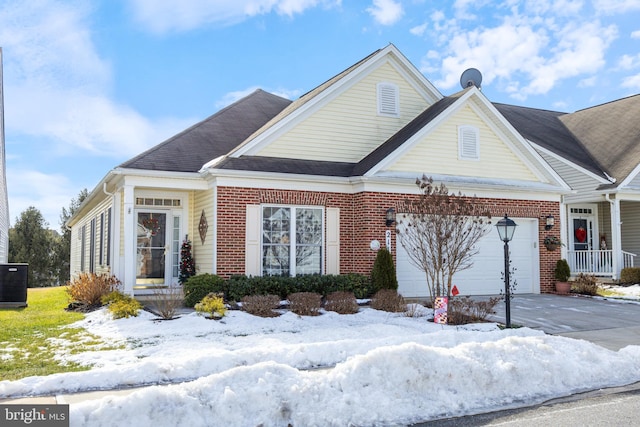 view of front of property featuring a garage and cooling unit