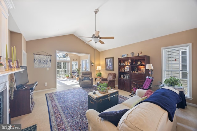 carpeted living room featuring ceiling fan and vaulted ceiling