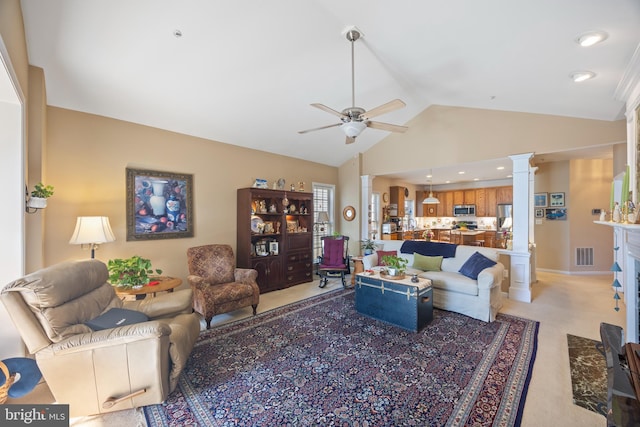 carpeted living room featuring ceiling fan, high vaulted ceiling, and decorative columns