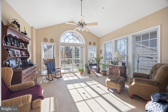 living room with vaulted ceiling, light colored carpet, and ceiling fan