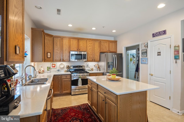 kitchen featuring a kitchen island, appliances with stainless steel finishes, and sink