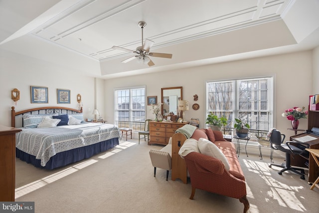 bedroom with light carpet, a raised ceiling, and ceiling fan