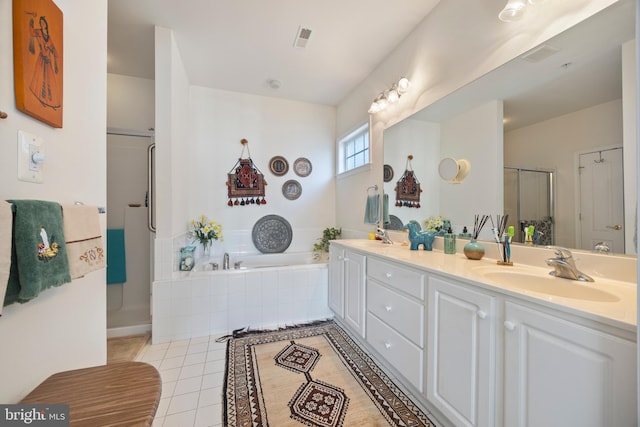 bathroom featuring vanity, independent shower and bath, and tile patterned flooring