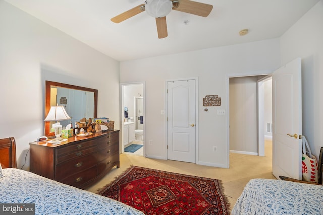 carpeted bedroom with ceiling fan and ensuite bath