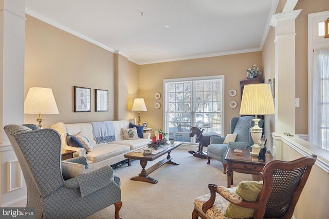 carpeted living room featuring ornamental molding and decorative columns